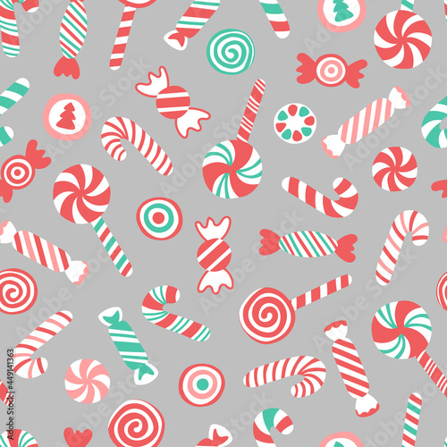 Vector seamless pattern with hand drawn candy canes, lollipops and candies. Cute design for Christmas wrappings, textile and backgrounds.