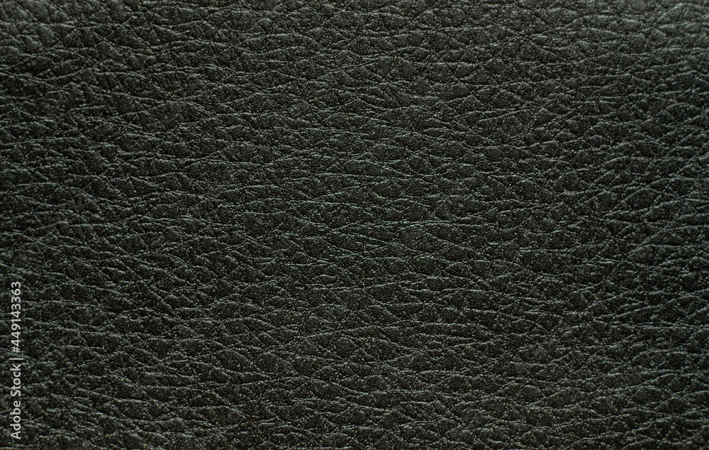 Photo of a rectangular black leather texture with convex circles Photo of a rectangular black leather texture with convex circles