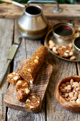 Fig and nut salami. Healthy vegan candy. Coffee