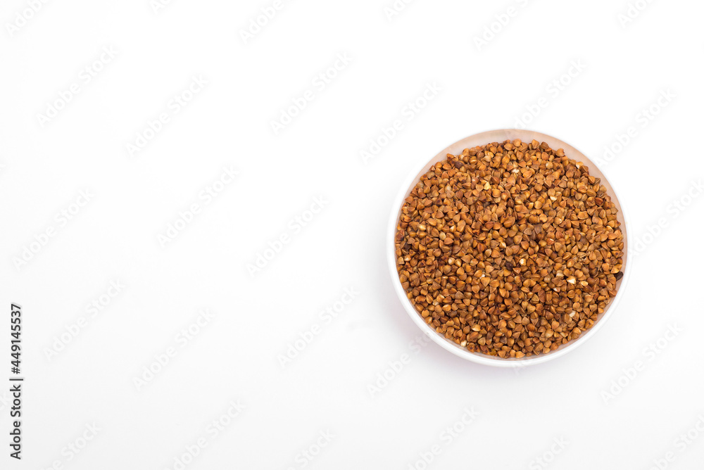 Pile of buckwheat isolated on white background. Top view. Buckwheat. Buckwheat grains. Grain culture. Pile of buckwheat isolated on white background. Top view. Buckwheat. Buckwheat grains. Grain culture.