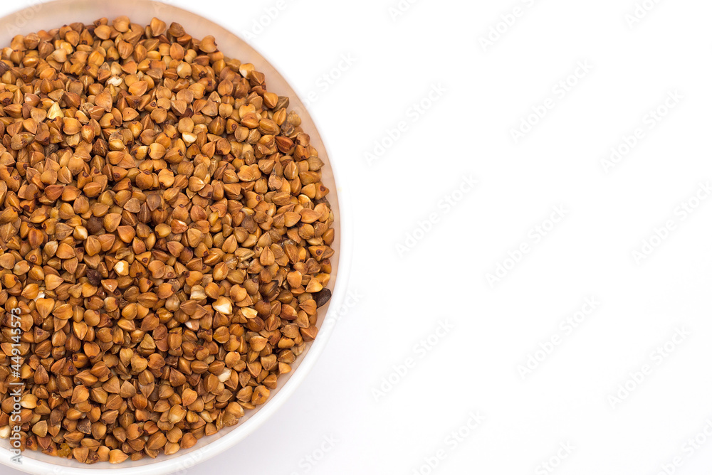 Pile of buckwheat isolated on white background. Top view. Buckwheat. Buckwheat grains. Grain culture. Pile of buckwheat isolated on white background. Top view. Buckwheat. Buckwheat grains. Grain culture.