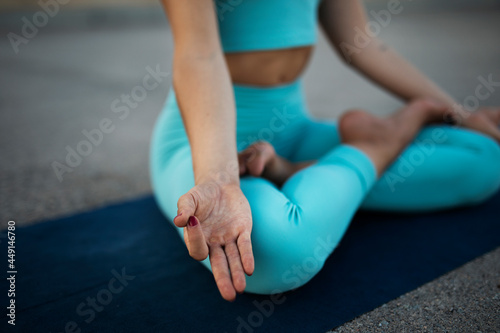 Pretty woman doing yoga exercises. Beautiful athlete woman doing stretching exercises.