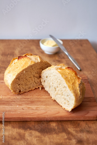 Homemade sourdough bread. Wood and white background. Butter.