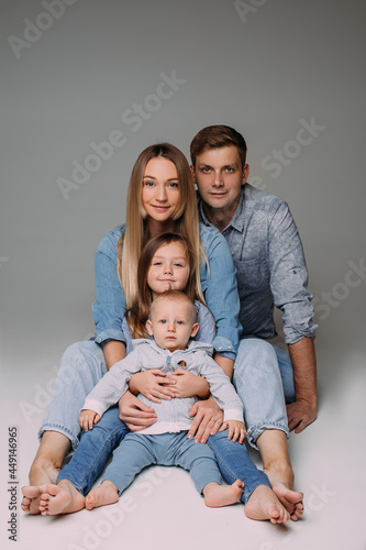 Family of four posing in denim dress code