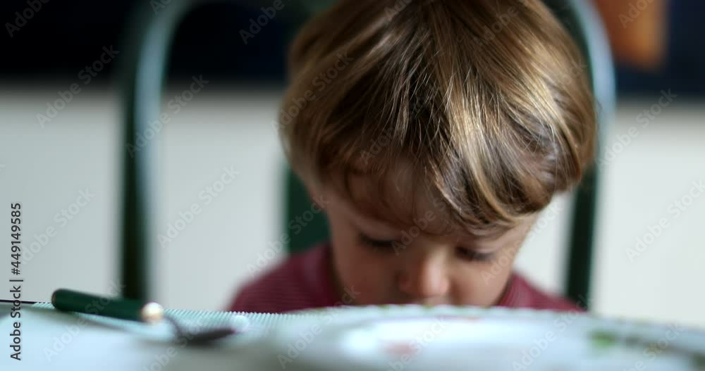 Careless child lets food fall on ground by accident Careless child lets food fall on ground by accident