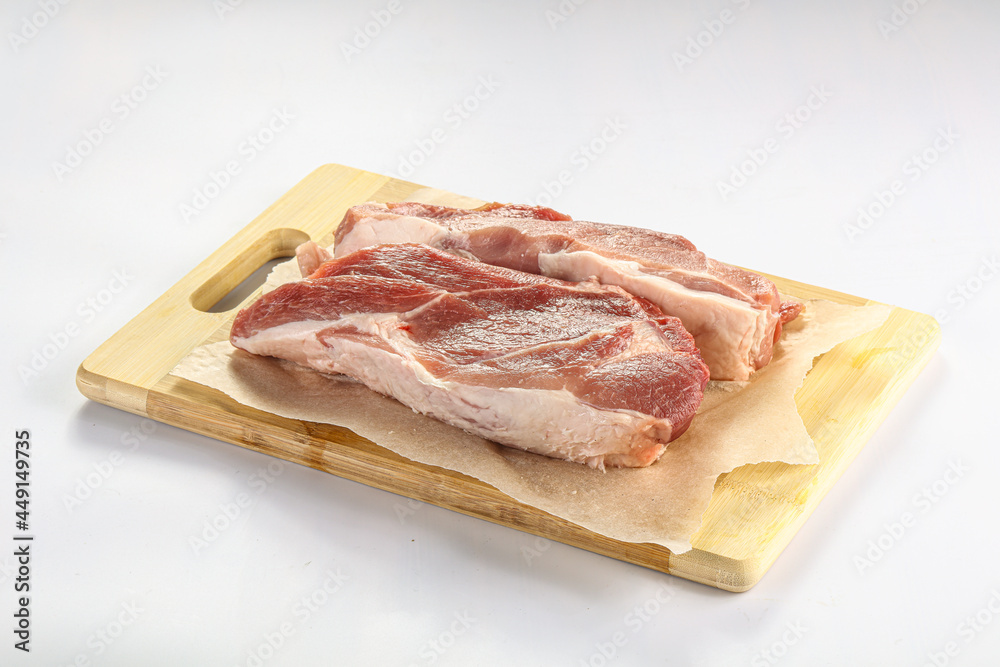 Raw pork fillet over board