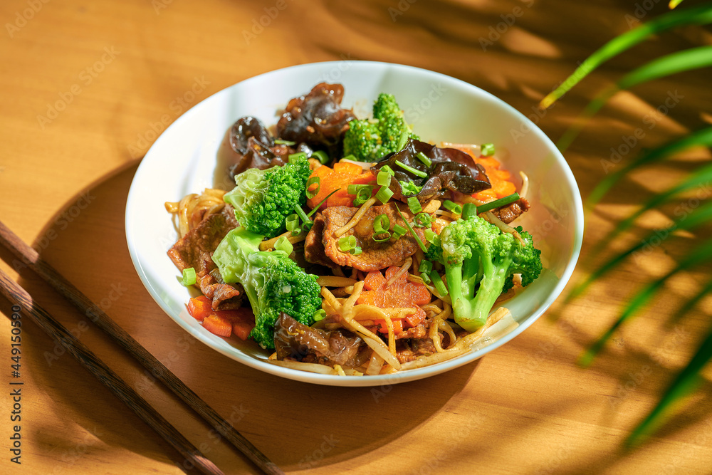 Wok noodles with vegetables and beef in a bowl. Chinese cuisine Wok noodles with vegetables and beef in a bowl. Chinese cuisine