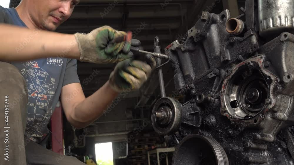 Internal combustion engine, diesel fuel, close-up. He's covered in black oil. It will be repaired or disposed of for scrap. car disassembly or repair of the car. Hands of master close-up. repairman. Internal combustion engine, diesel fuel, close-up. He's covered in black oil. It will be repaired or disposed of for scrap. car disassembly or repair of the car. Hands of master close-up. repairman.