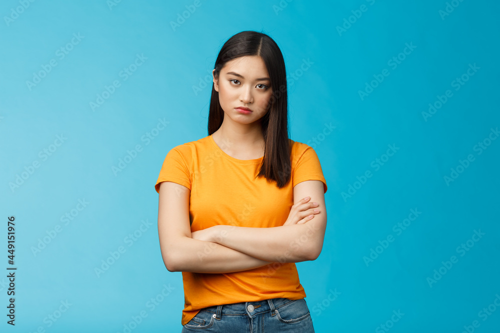 Serious-looking indifferent and upset intense asian woman brunette, cross arms chest look strict ignorant, pissed listening nonsense, annoyed stupid conversation, stand blue background - obrazy, fototapety, plakaty 