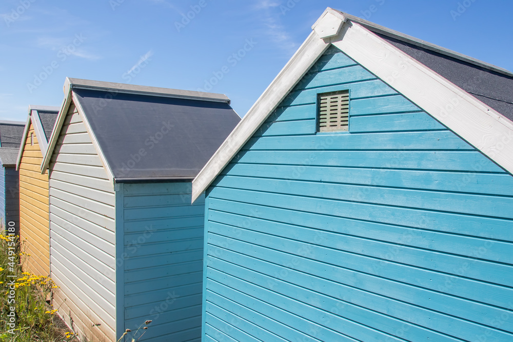 Colourful painted wooden beach huts or sheds with ventilation grill. Colourful painted wooden beach huts or sheds with ventilation grill.