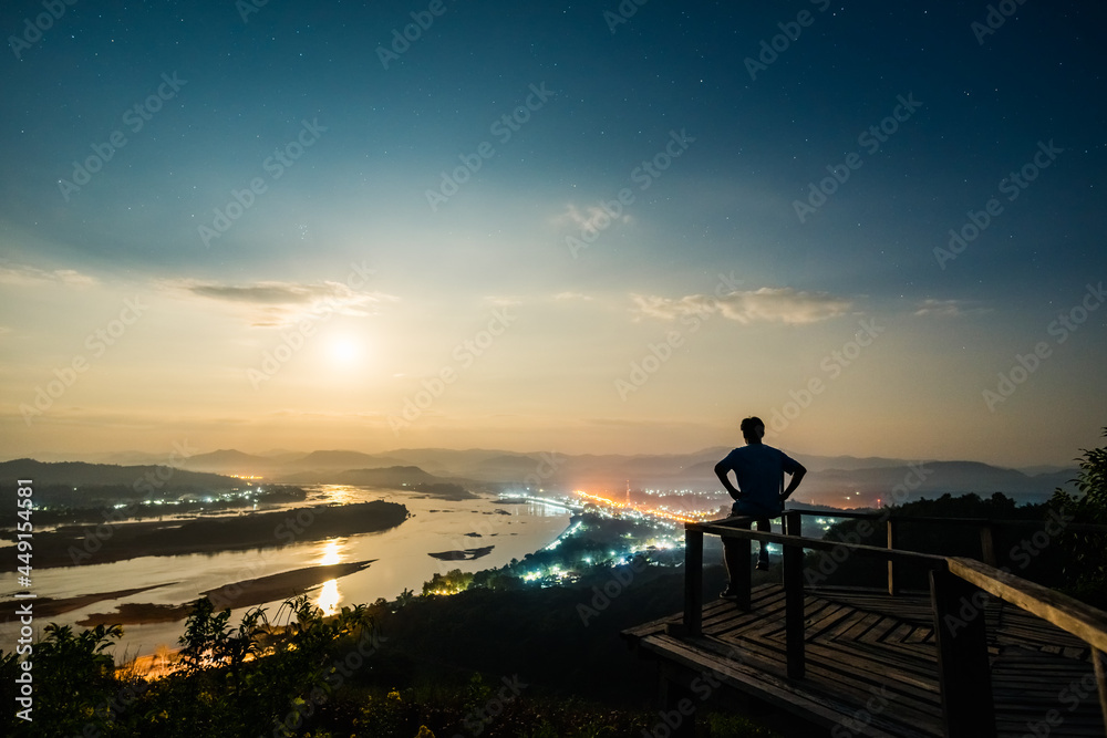 landscape of Mekong River in Night sky with the man on wooden bridge