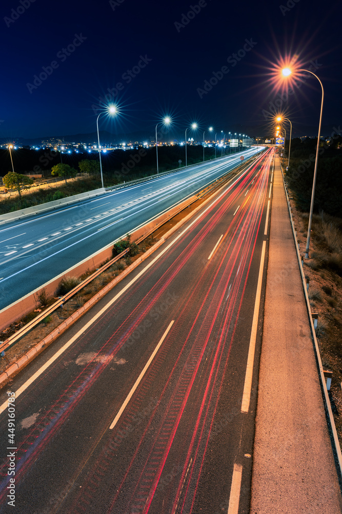 long exposure photograph of highway at night with light beams from cars