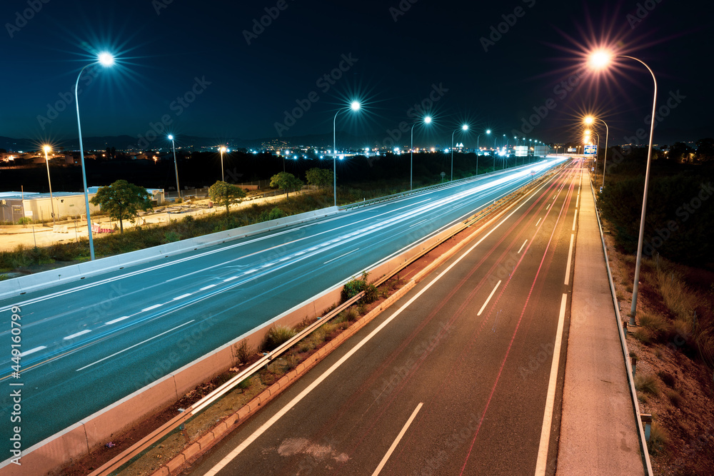 long exposure photograph of a road at night with light beams from cars