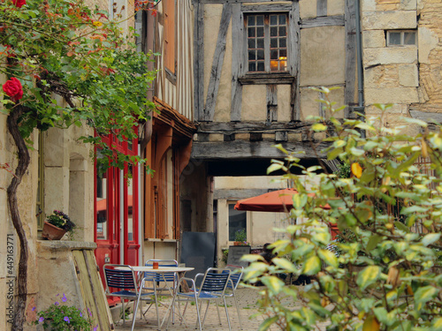 Empty restaurant in a narrow street of a French town of Noyers sur Serein in Burgundy, one of the most beautiful villages of France with historic architecture during Covid-19 coronavirus pandemic