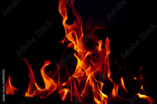 Orange flame on black background. Heat energy heap closely  red and yellow