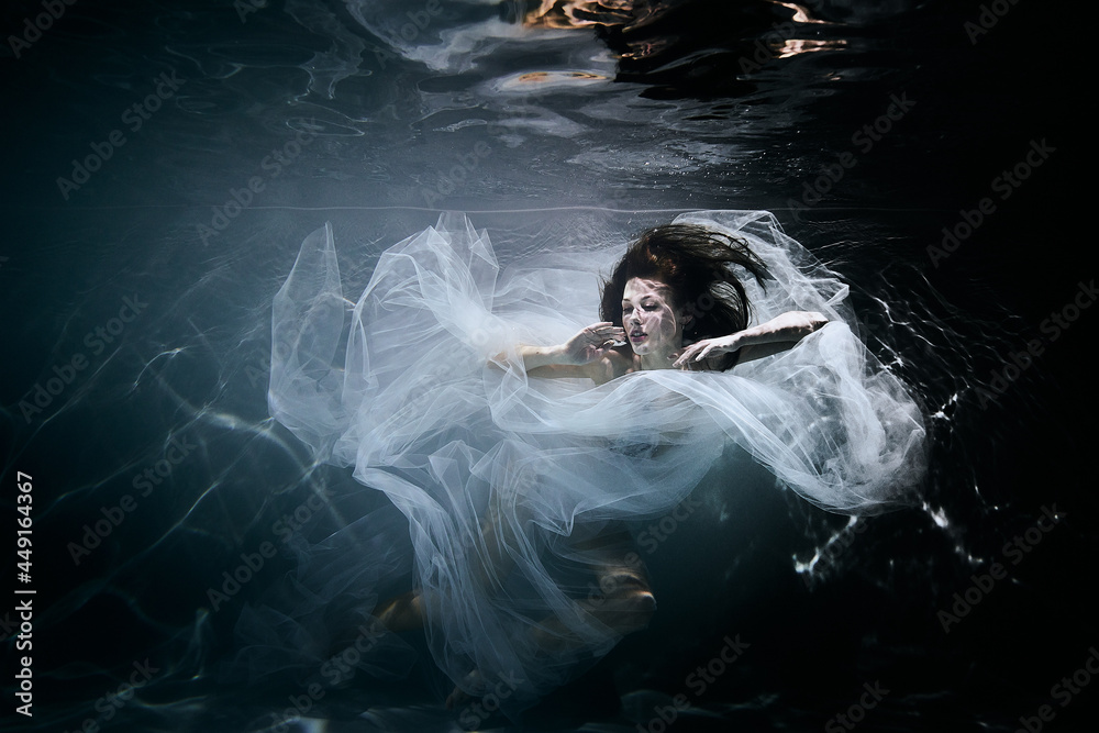 Woman in the water in white dress