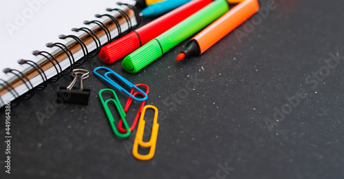 School supplies top view on the background of the chalkboard.