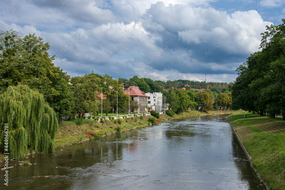 Polish-Czech border on the Olza river in Cieszyn on a summer day with beautiful clouds in the background