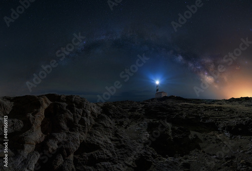 Milky way arch over a lighthouse