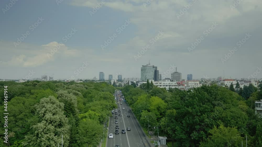 Skyline aerial landscape of metropolitan city with top view of boulevard, cars and park. Urban scene of modern town with busy streets. Panoramic view of architecture and lifestyle