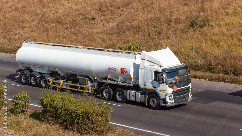 Industrial White Truck Fuel Liquid Tanker Driving Highway On Route to Travel Destination