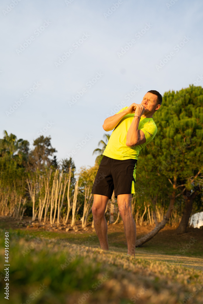 At sunset a sporty man in sneakers starts his morning run At sunset a sporty man in sneakers starts his morning run