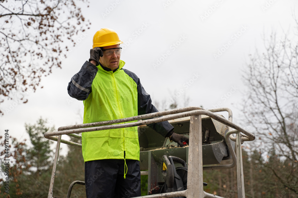 Man builder repairman in yellow helmet makes repairs on the roof
Man builder repairman in yellow helmet makes repairs on the roof