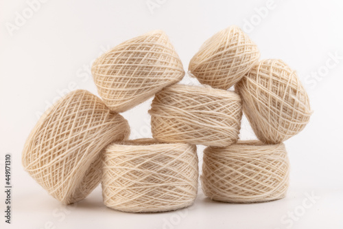 balls of light woolen thread on white background. natural wool. knitting. background