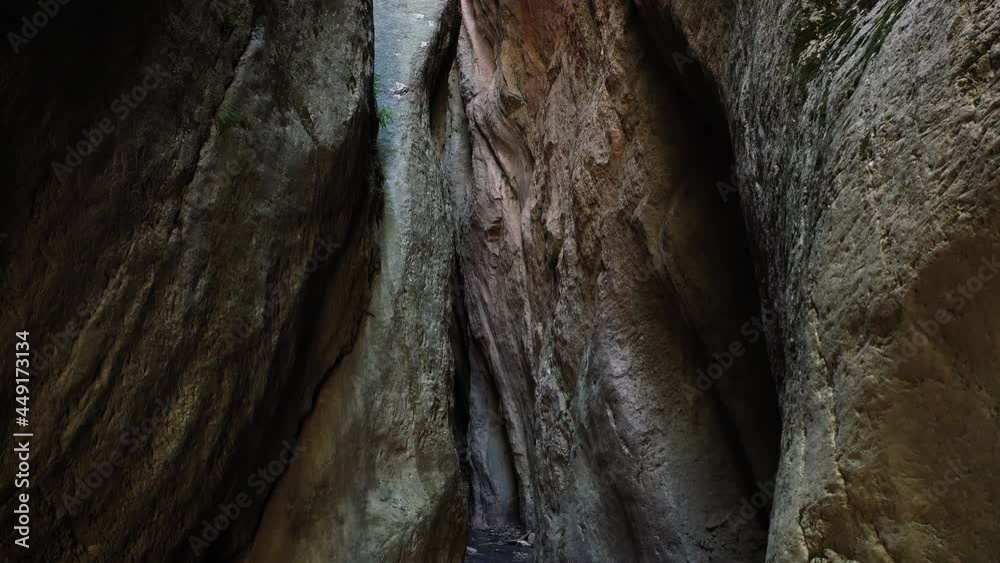 Camera move at the narrow canyon of a mountain cave, illuminated by the sun.Beautiful rocky cave Camera move at the narrow canyon of a mountain cave, illuminated by the sun.Beautiful rocky cave