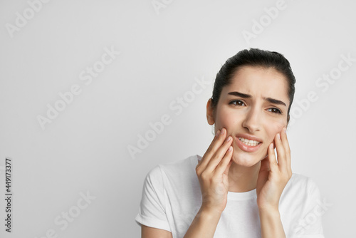 woman in white t-shirt toothache discomfort close-up