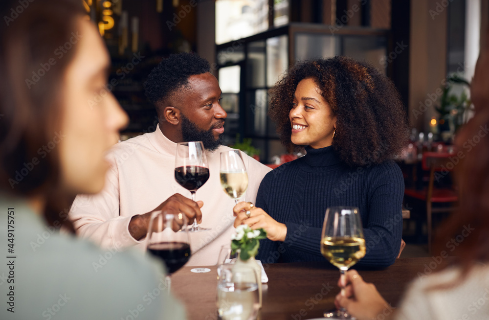 Young couple toasting in wine bar