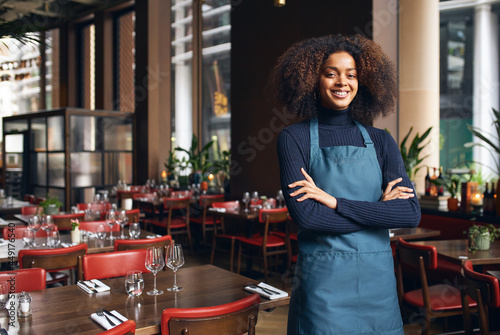 Cheerful small business owner in restaurant photo