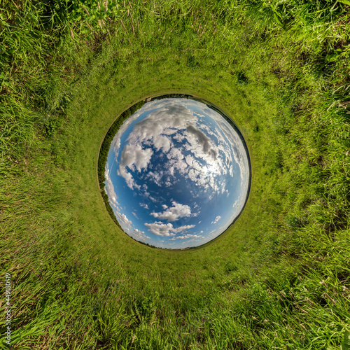 blue sky ball in middle of swirling asphalt road or field. Inversion of tiny planet transformation of spherical panorama 360 degrees. Spherical abstract view. Curvature of space.