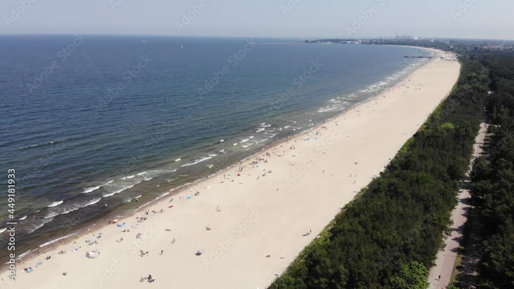 Aerial view of beach at the Baltic Sea in Poland. People are sunbathing on the beach. Aerial view of beach at the Baltic Sea in Poland. People are sunbathing on the beach.