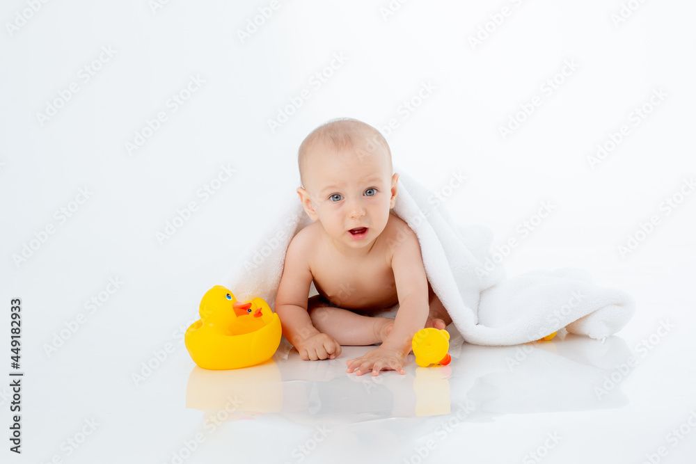 baby boy in a towel after bathing sitting on a white background isolated baby boy in a towel after bathing sitting on a white background isolated