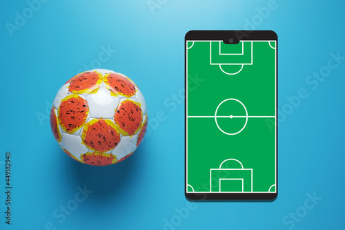 Slika na platnu A picture of football ball with smartphone football field illustration