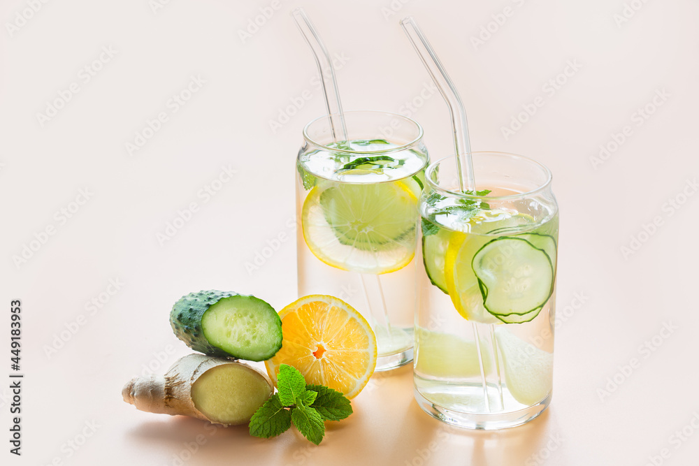Sassi water. Detox drink with lemon, cucumber, ginger and mint. Healthy food concept. Glass straws Sassi water. Detox drink with lemon, cucumber, ginger and mint. Healthy food concept. Glass straws