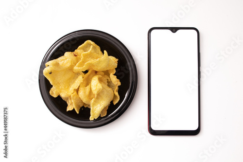 cell phone and snacks on a white background photo