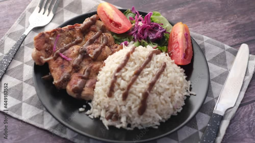 grill chicken , rice and salad on plate on table grill chicken , rice and salad on plate on table