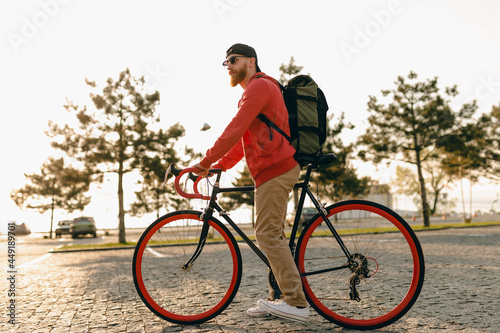 handsome bearded man traveling with bicycle in morning