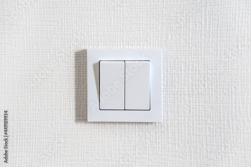 White light switch on a white wall photo