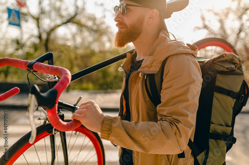 handsome bearded man traveling with bicycle in morning