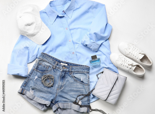 Composition with female clothes, shoes and accessories on white background
