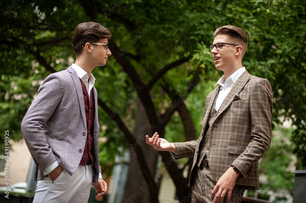 Two young businessmen communicate and solve problems with each other Two young businessmen communicate and solve problems with each other