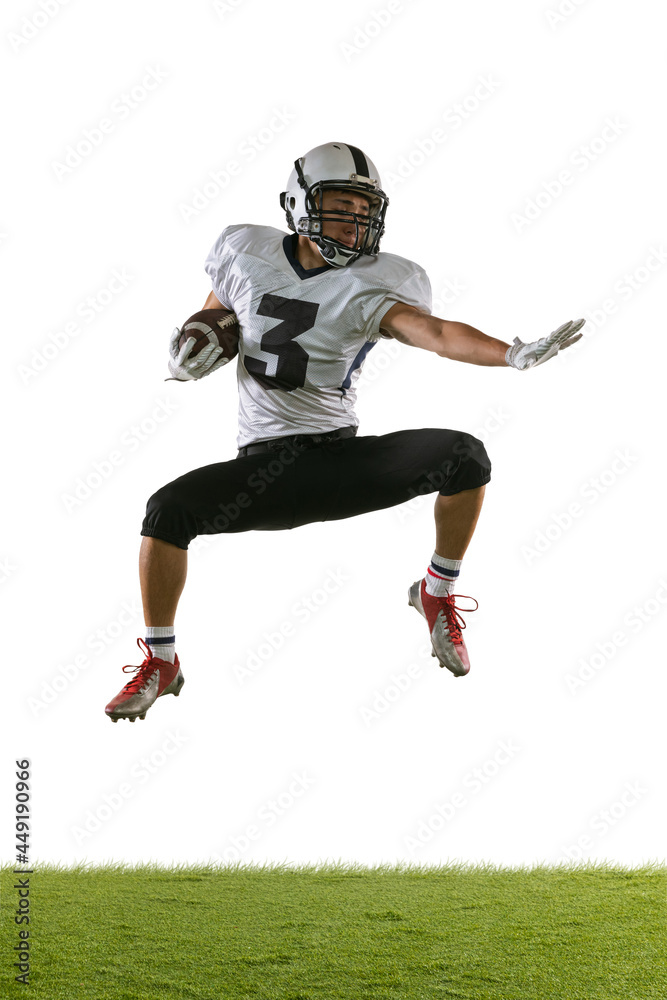 Portrait of American football player training isolated on white studio background with green grass. Concept of sport, competition Portrait of American football player training isolated on white studio background with green grass. Concept of sport, competition