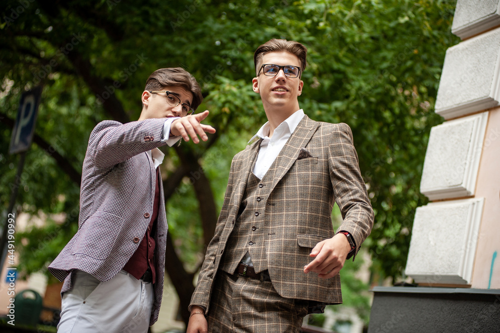 Two young businessmen communicate and solve problems with each other Two young businessmen communicate and solve problems with each other