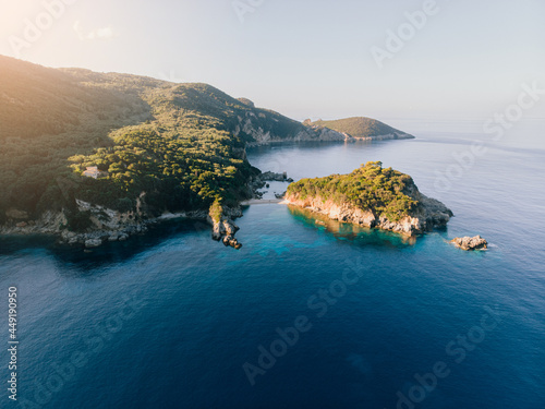 Aerial view of Corfu island. Blue lagoon is flooded with sunlight.