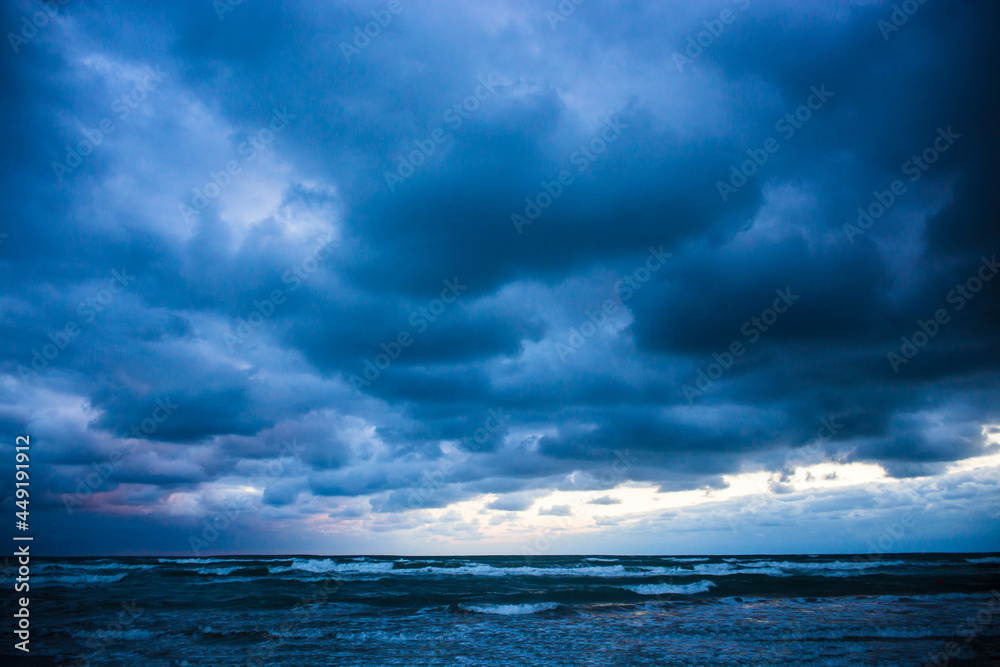 Beautiful dramatic seascape. Stormy waves and blue rain clouds. Copy space.