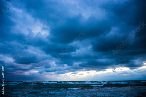 Beautiful dramatic seascape. Stormy waves and blue rain clouds. Copy space.