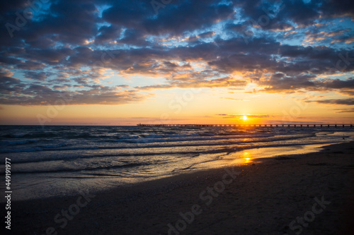 Evening sea landscape. Small waves flow to the sandy shore. Large light cloud in the sky. Copy space. © shaploff